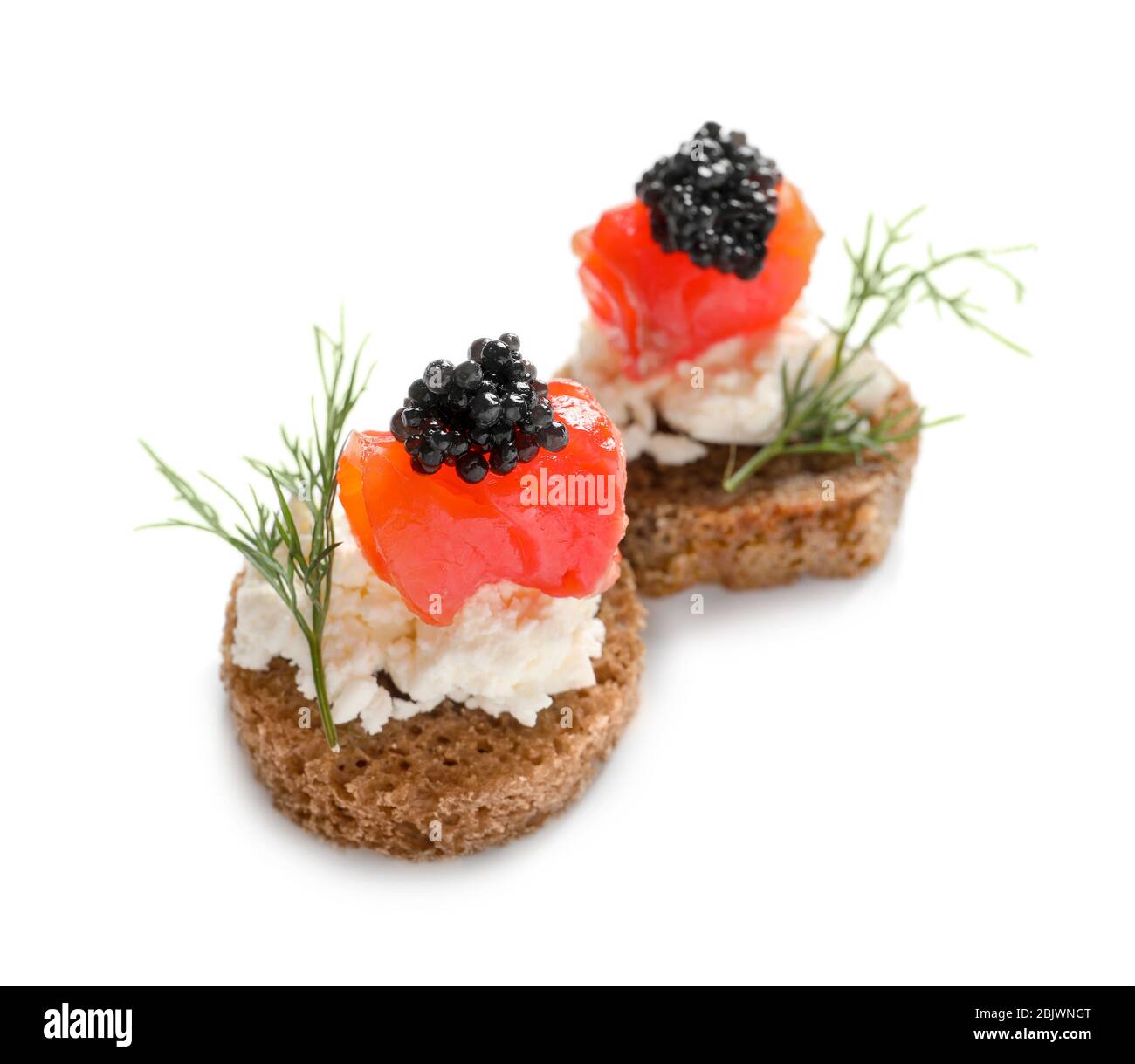 Delicious canapes with black caviar on white background Stock Photo