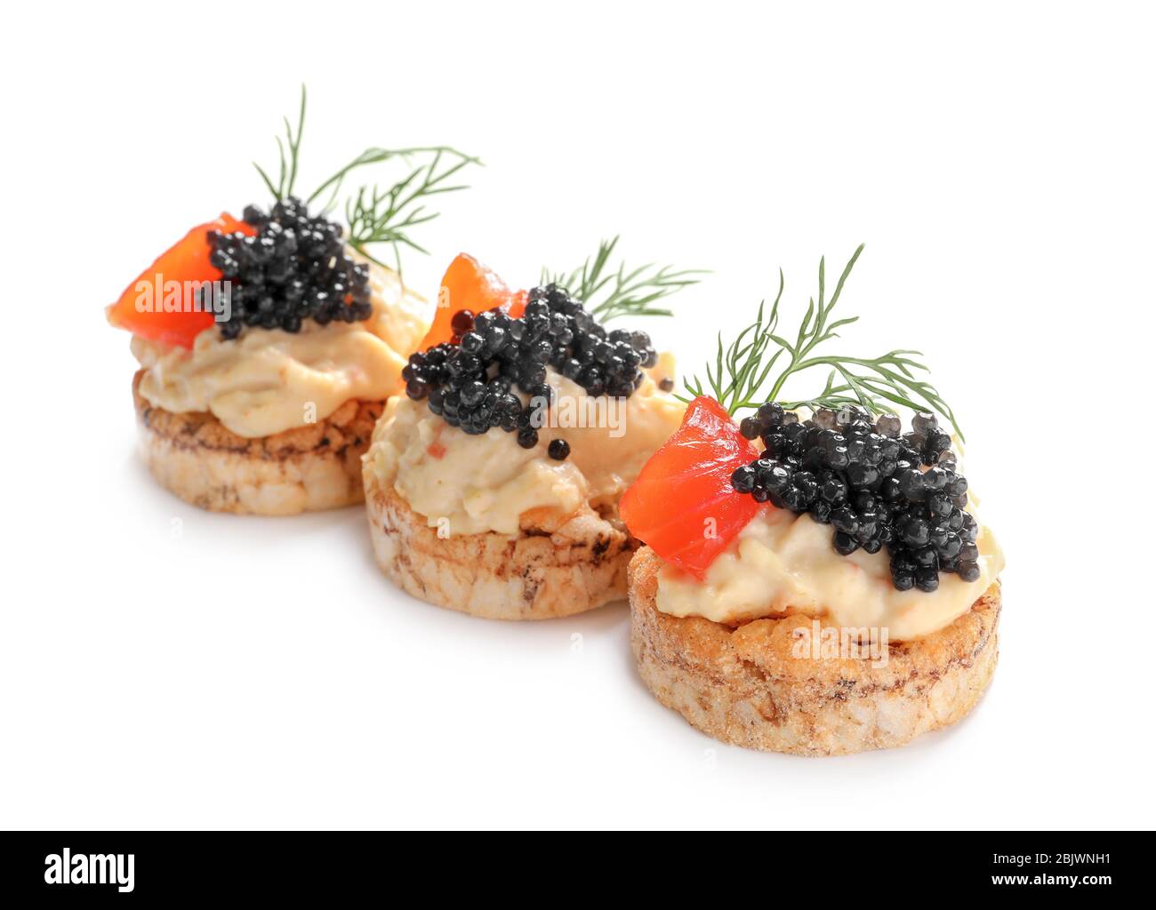 Delicious canapes with black caviar on white background Stock Photo
