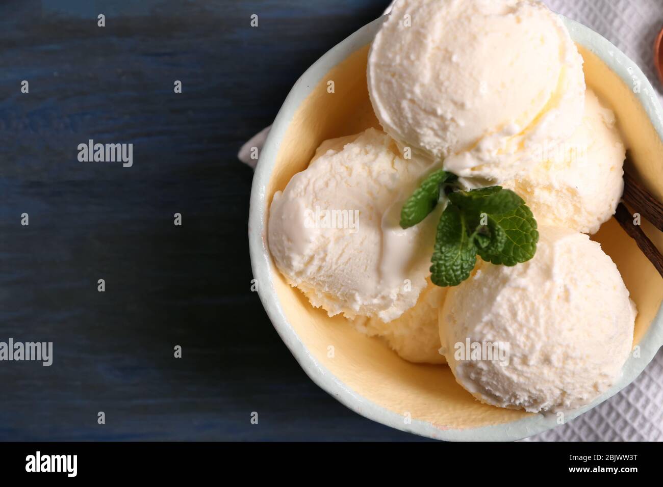 Bowl with delicious vanilla ice cream on table Stock Photo - Alamy