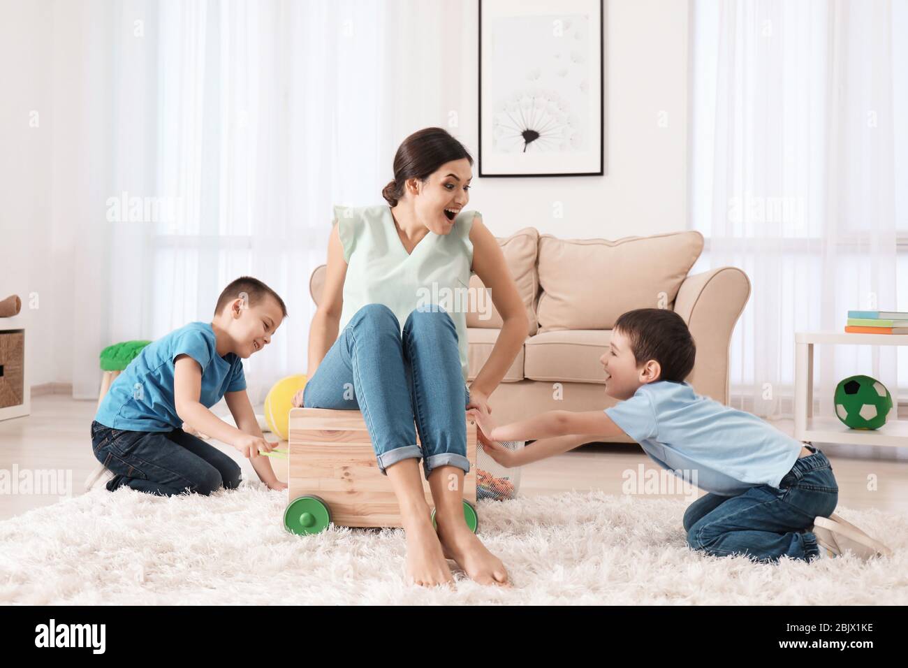 Two little boys playing with nanny at home Stock Photo - Alamy