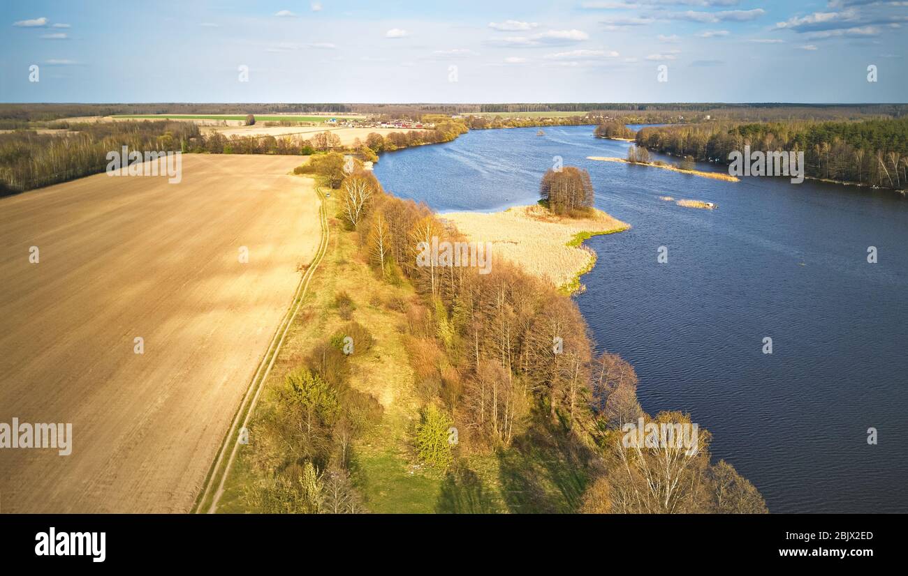 Windy Spring Scene Spring windy day. Ripples on the water reservoir. April weather rural ...