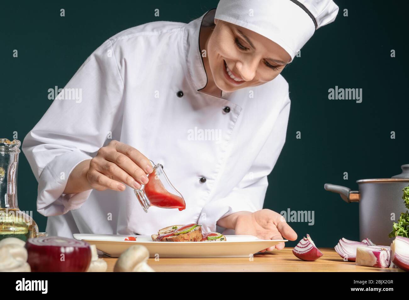 Female chef adding blue hi-res stock photography and images - Alamy
