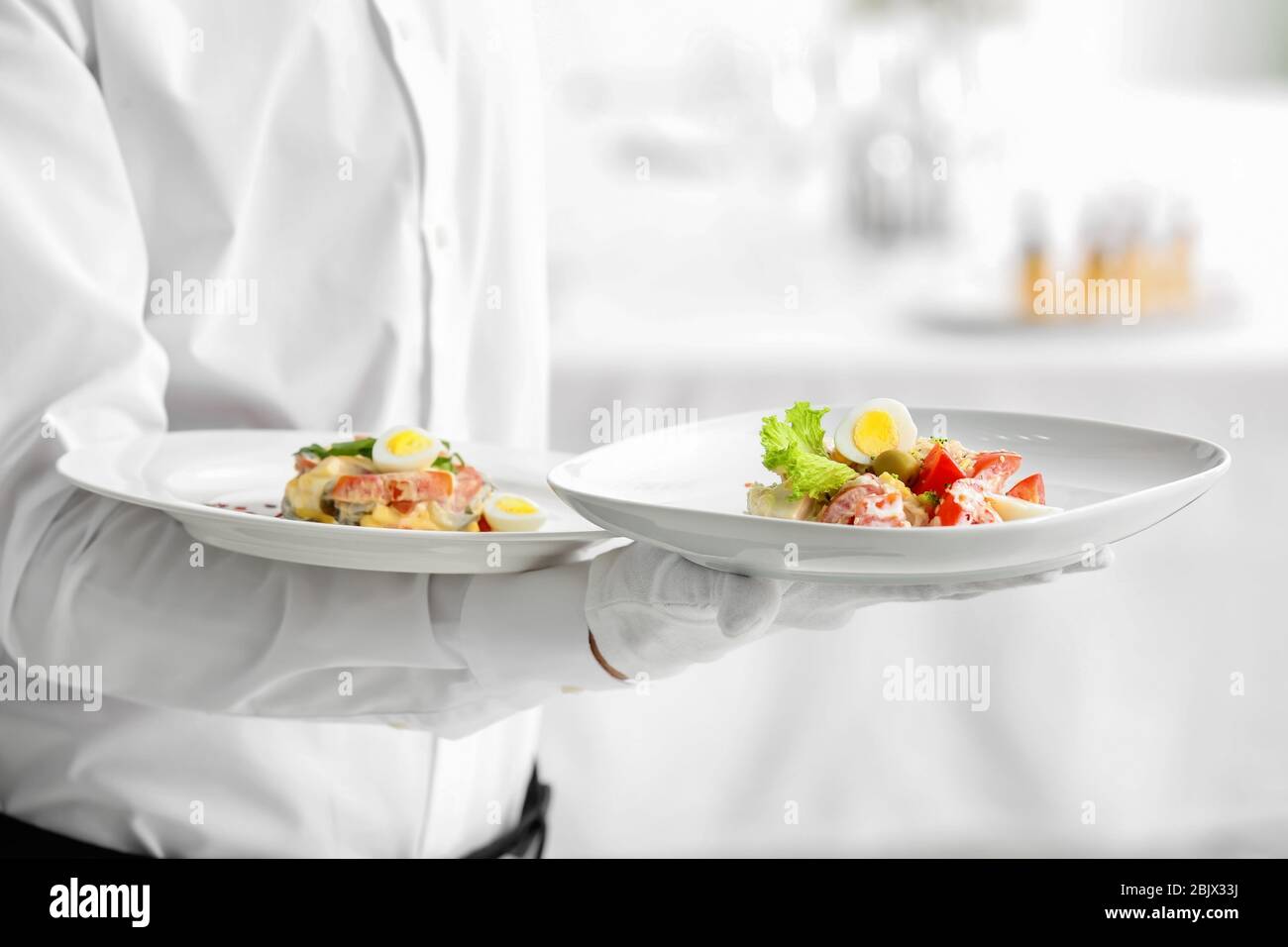Waiter holding plates with dishes, closeup Stock Photo Alamy