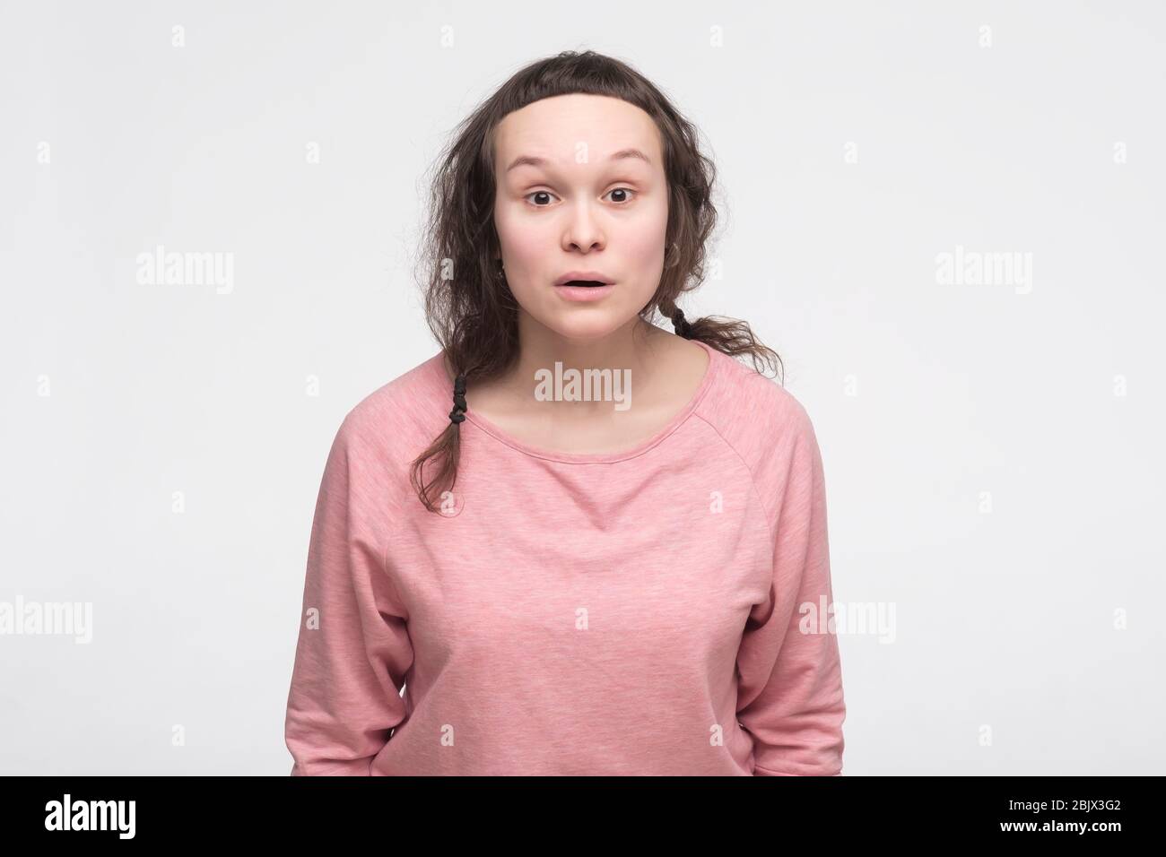 Young caucasian woman with surpised facial emotion raising eyebrows up