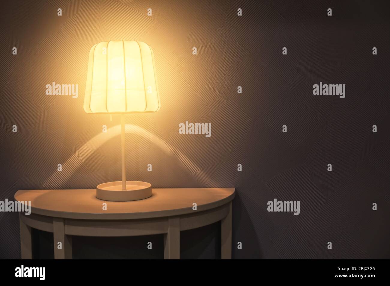 Stylish table lamp in dark room Stock Photo Alamy
