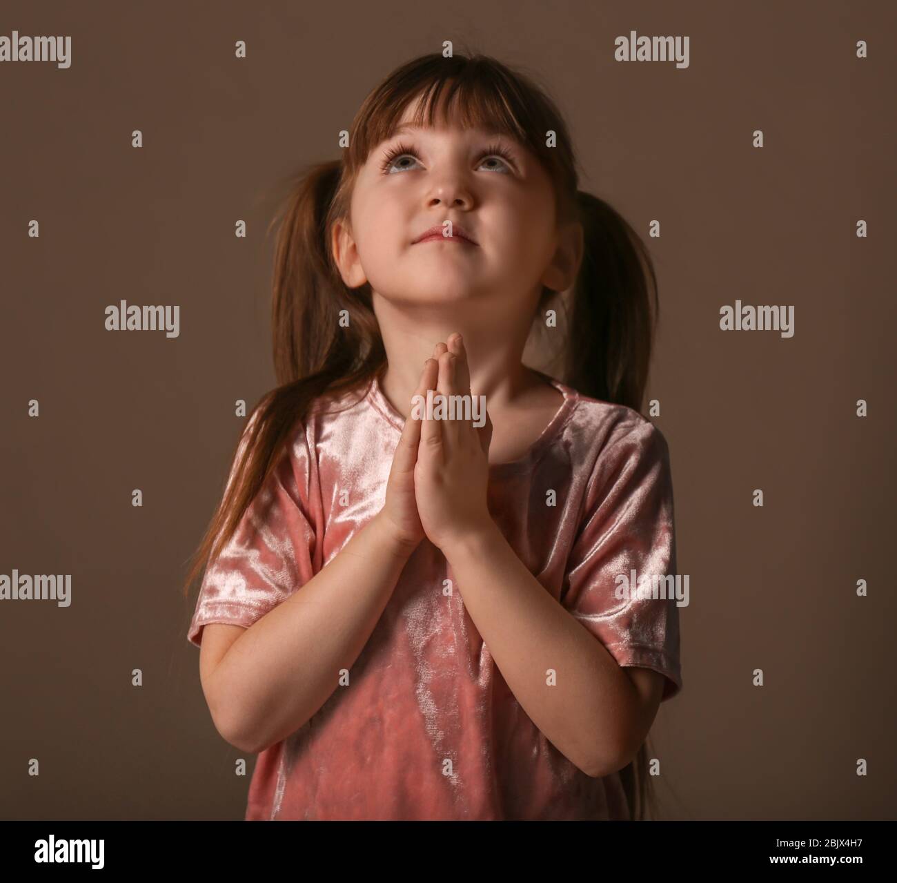 Religious Christian girl praying on dark background Stock Photo Alamy