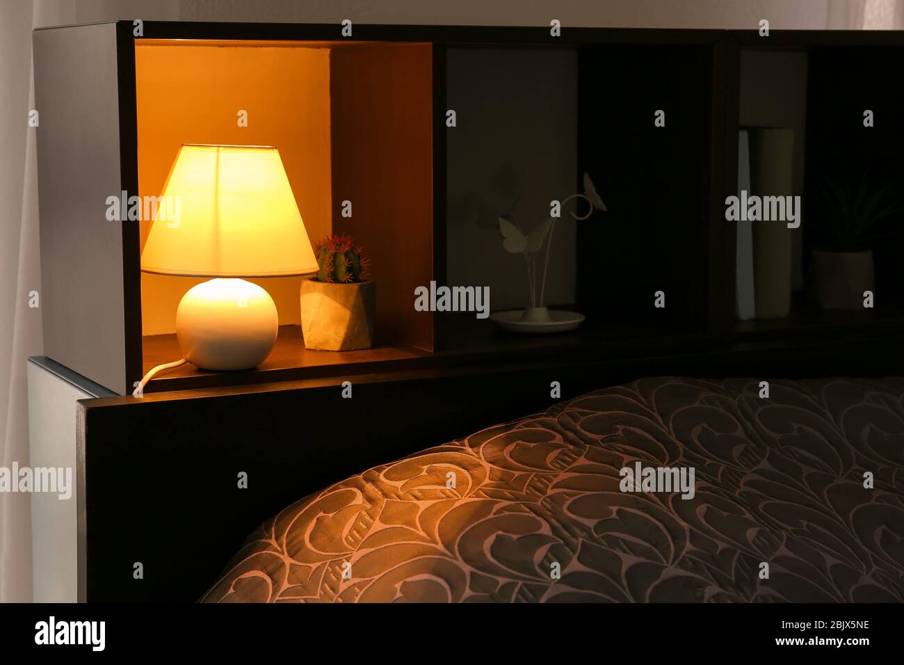 Shelving unit with elegant lamp in room Stock Photo Alamy