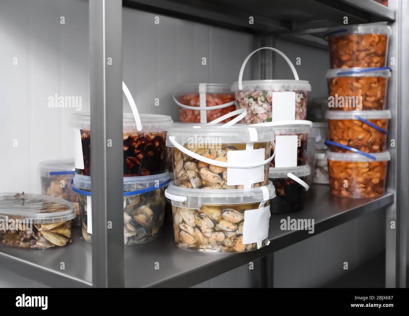 Shelf with marinated seafood in pantry of restaurant Stock Photo Alamy