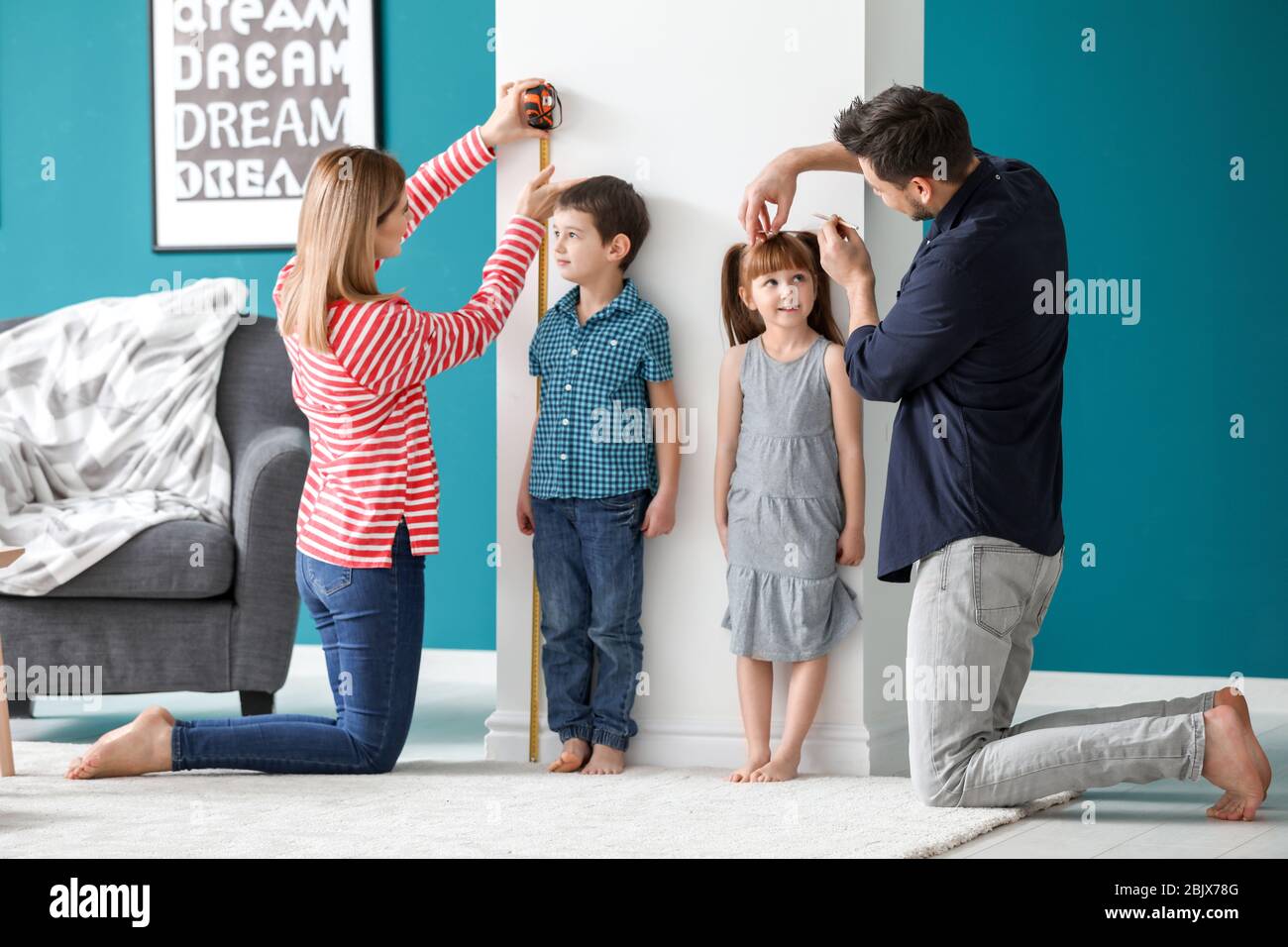 Parents measuring height of their children at home Stock Photo Alamy