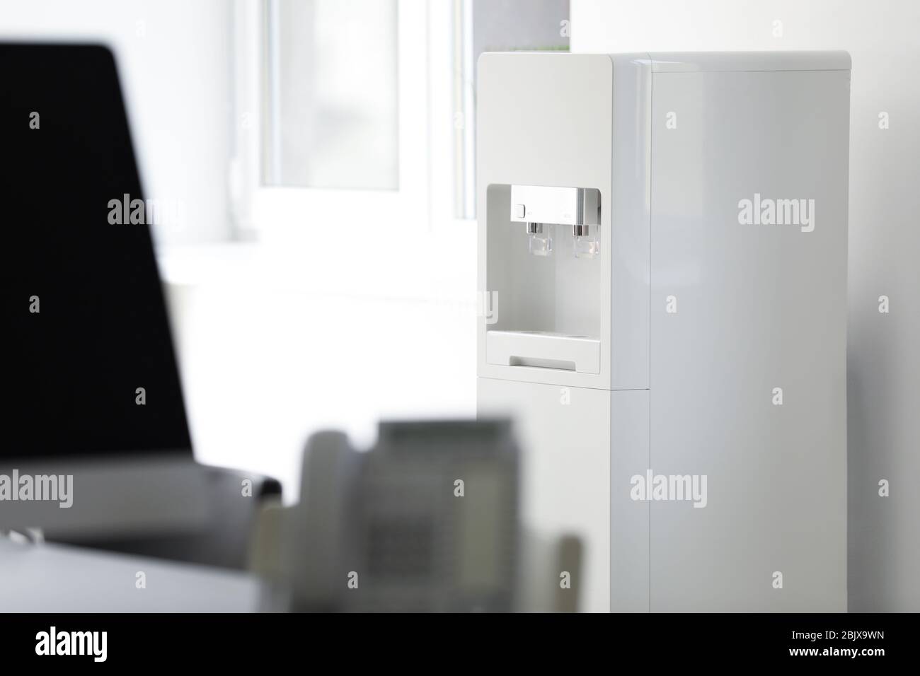 Modern water cooler in office Stock Photo Alamy