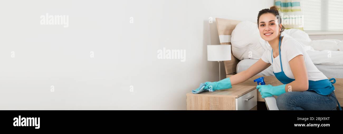 Home Bedroom Cleaning Service And Housekeeping Maid Stock Photo