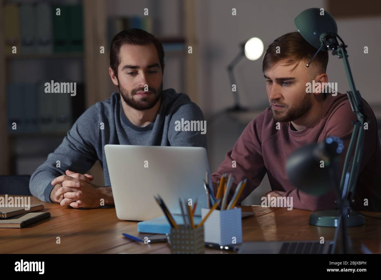 Students doing homework together indoors late at night Stock Photo - Alamy