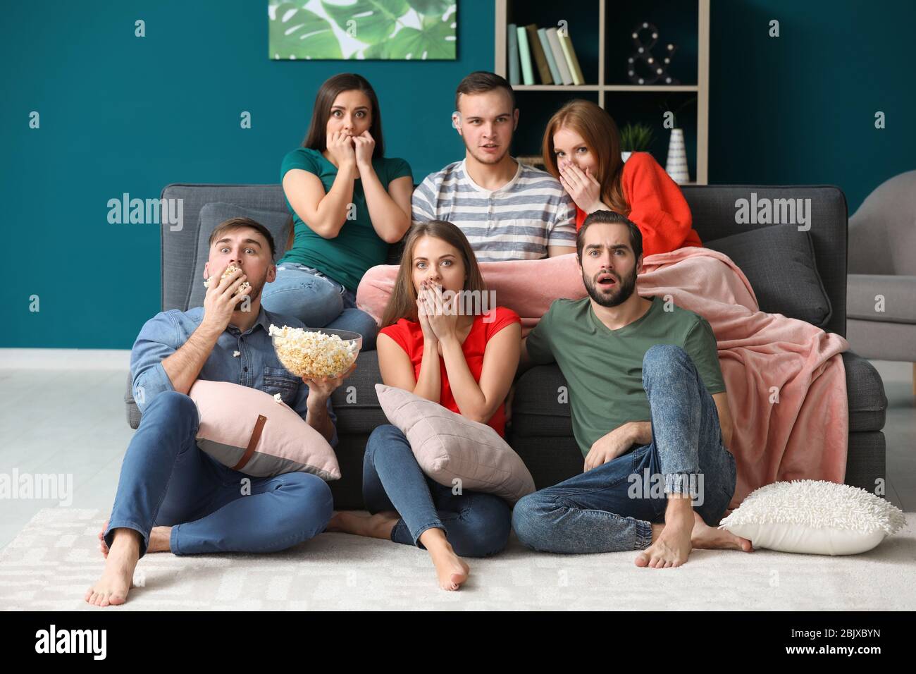 Young people watching TV at home Stock Photo