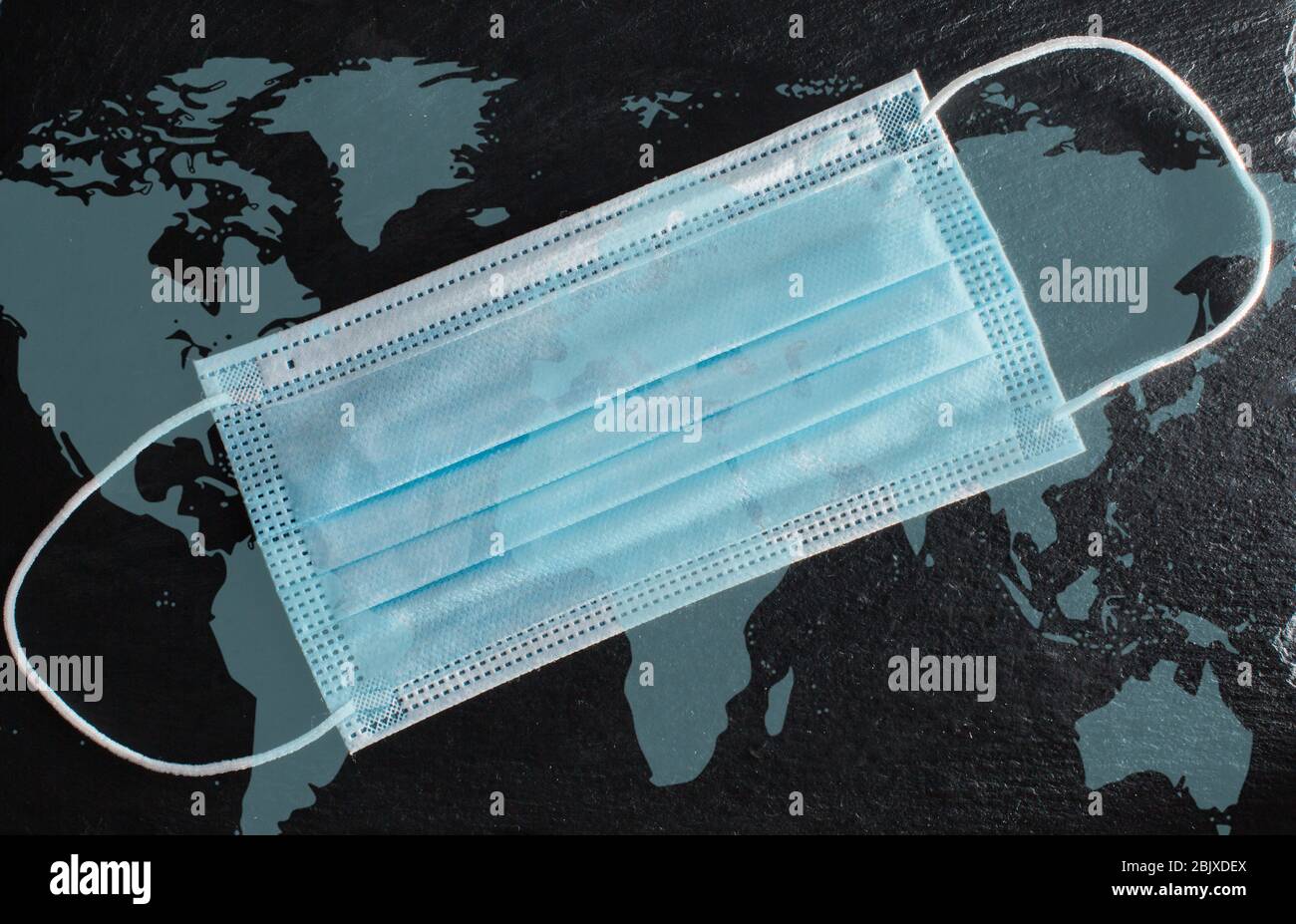 Medical protective mask on black background with Covid-19 text and ...