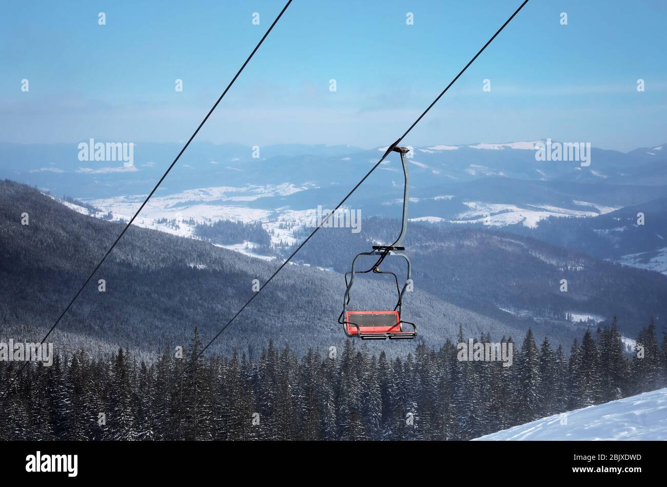 Ski lift at snowy resort in mountains. Winter vacation Stock Photo - Alamy
