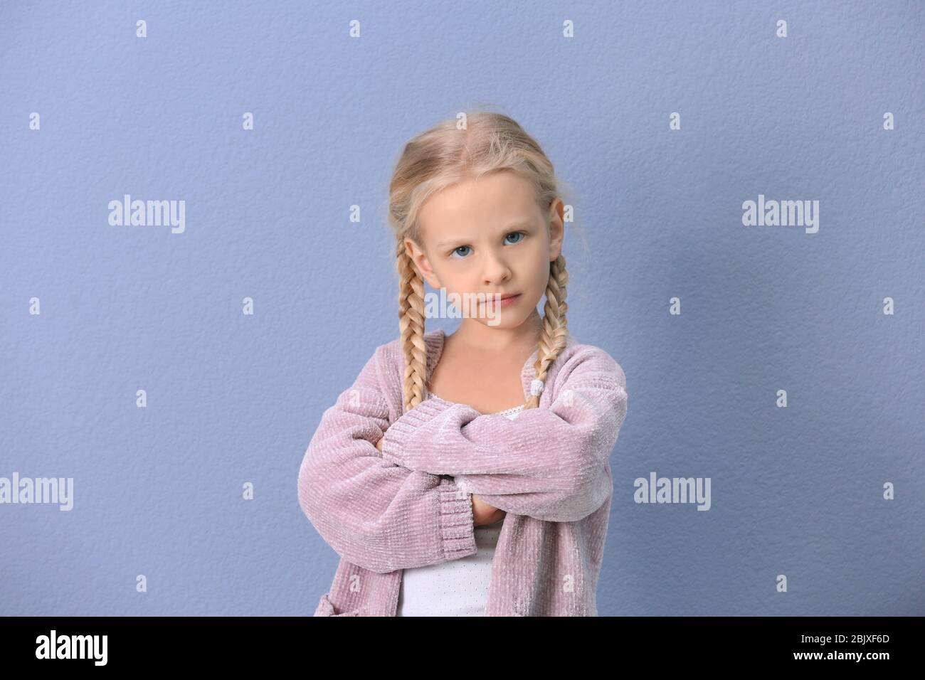 Portrait of emotional little girl on color background Stock Photo - Alamy