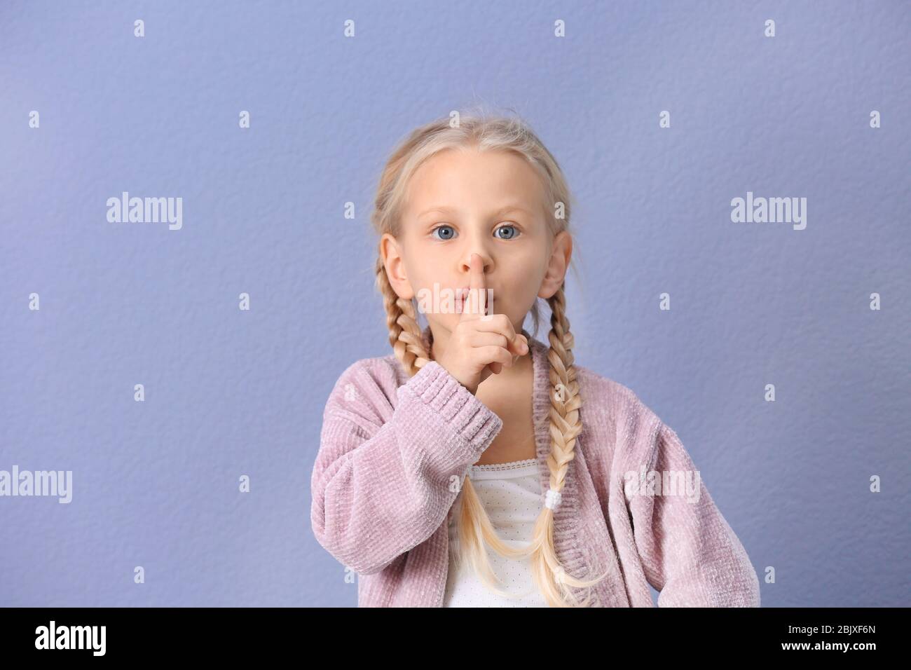 Portrait of emotional little girl on color background Stock Photo