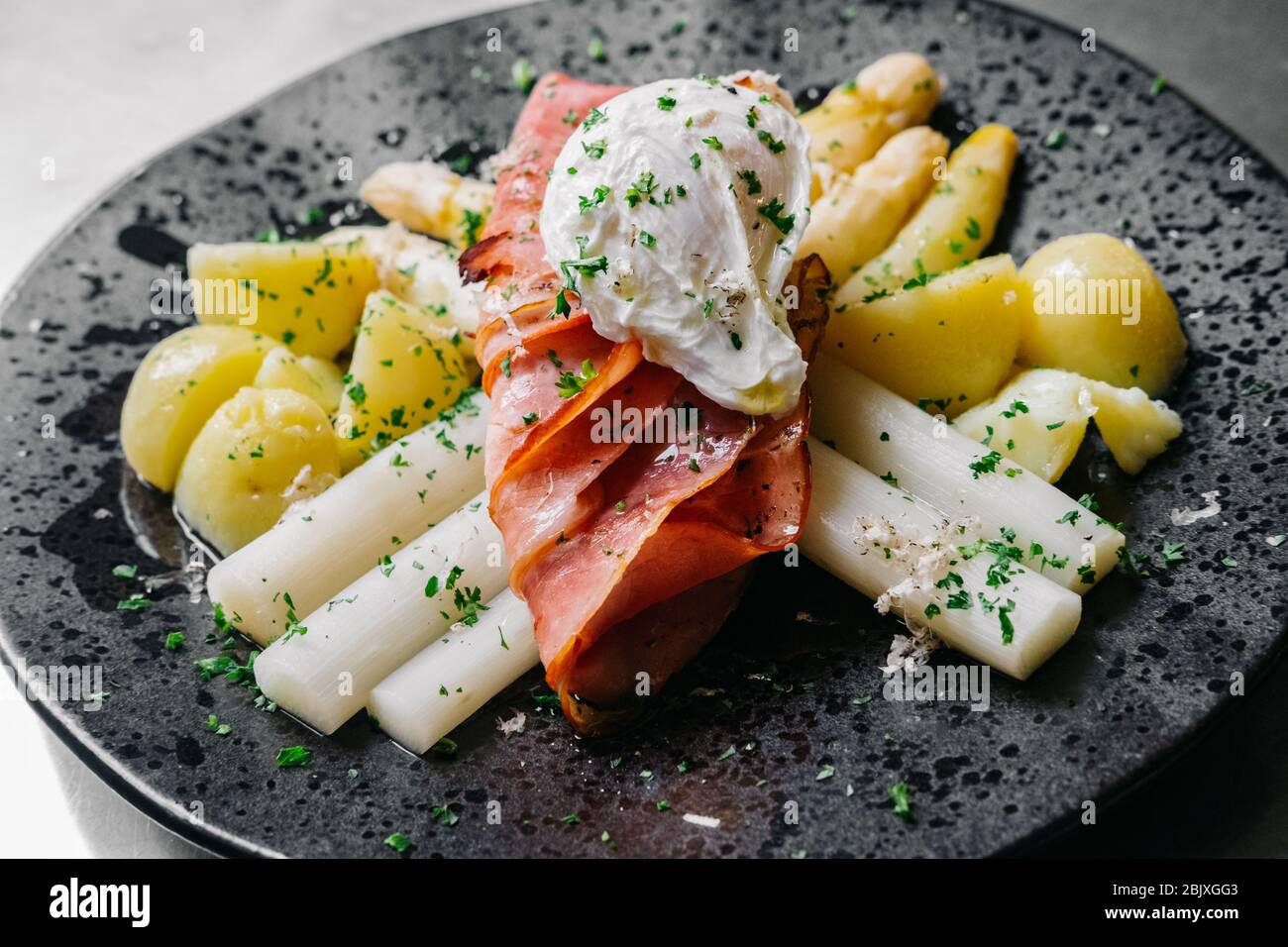 Dutch White Asparagus with Ham, Eggs and Potatoes. Asparagus Hollandaise Stock Photo
