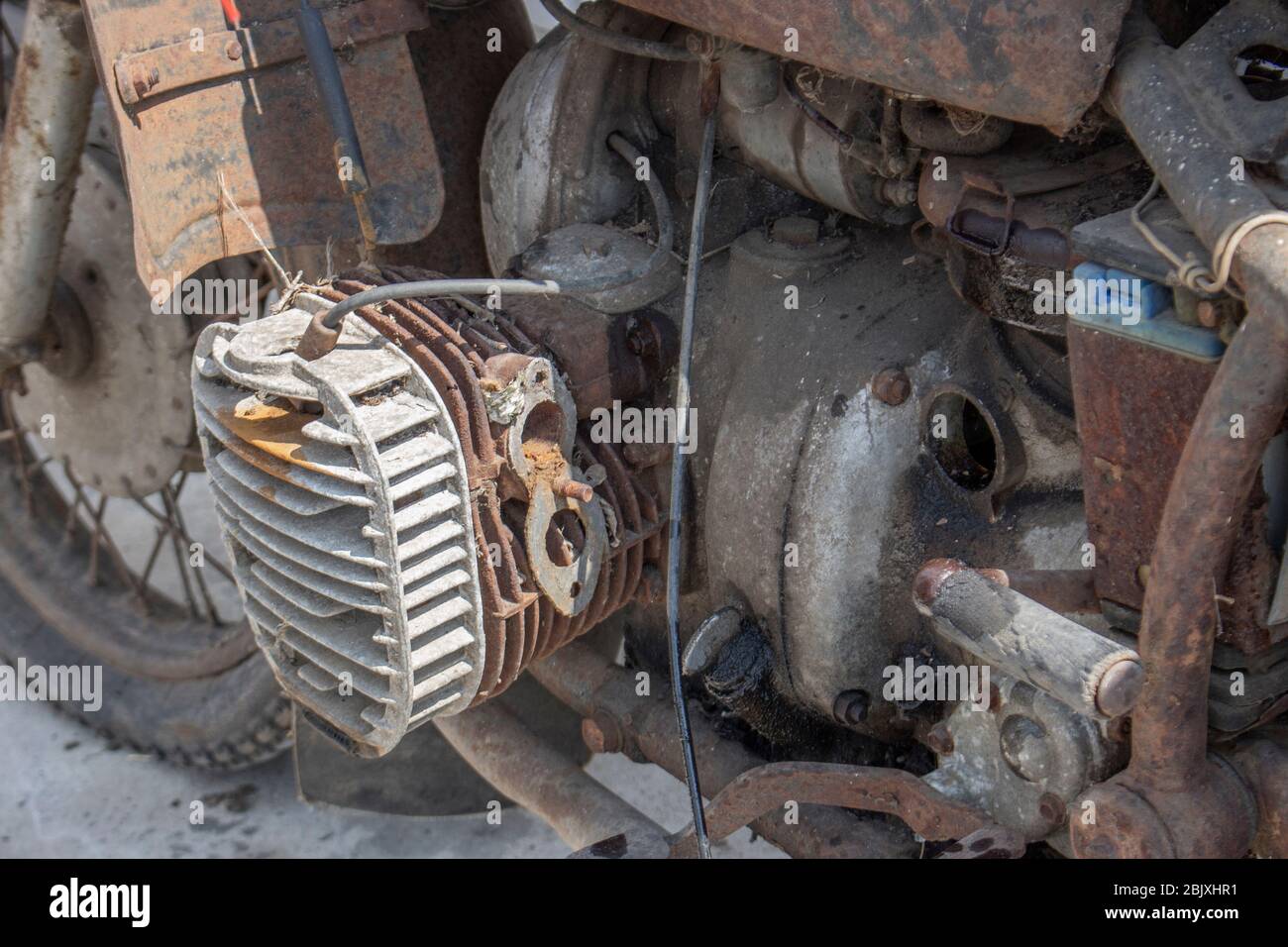 Old antique bike covered with rust. Engine retro moto, dirt and plaque. Stock Photo
