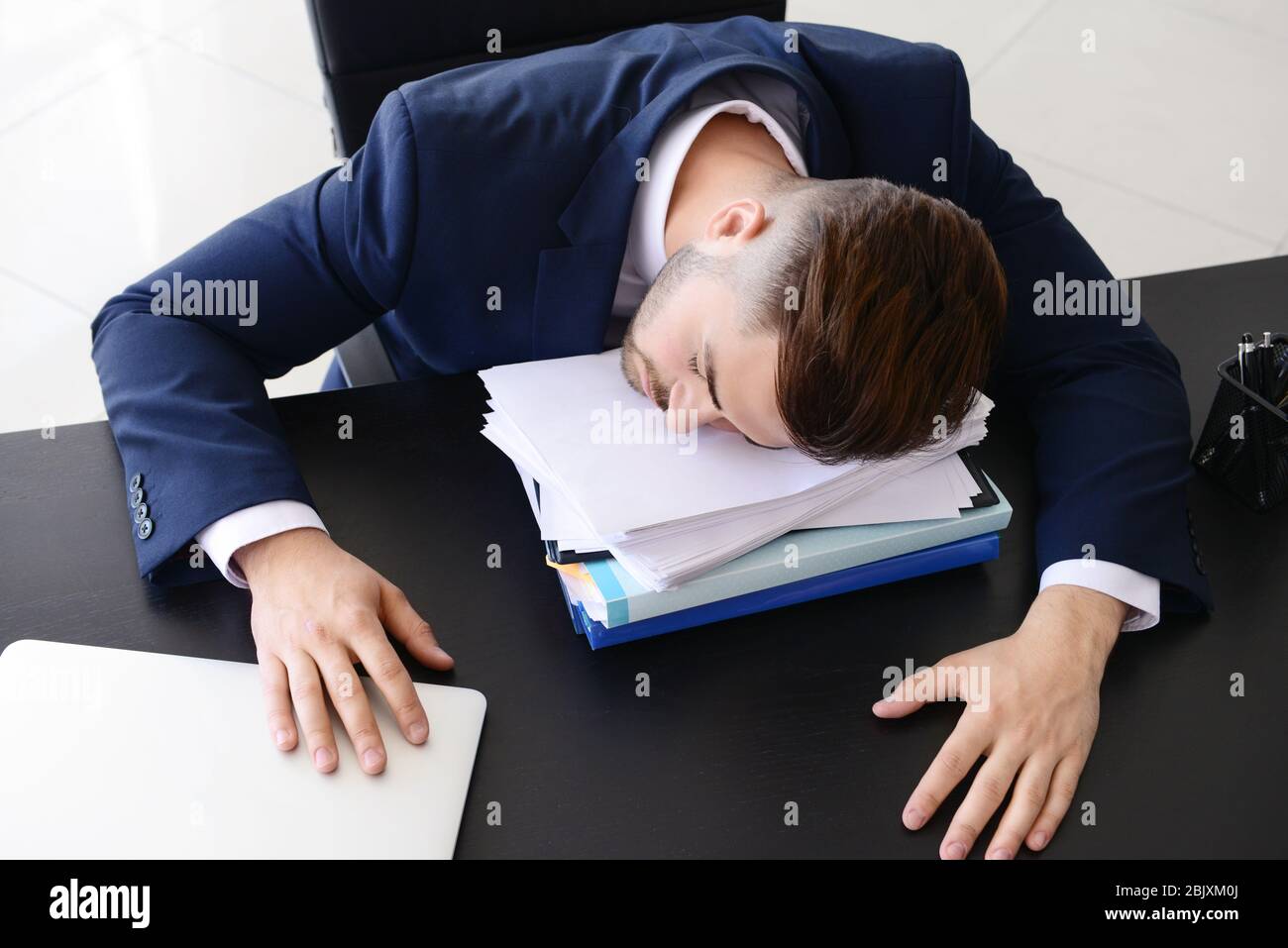 Tired businessman sleeping in office Stock Photo - Alamy