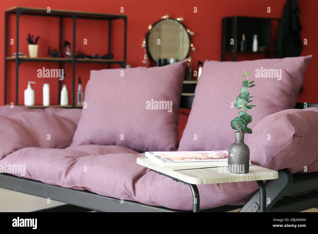 Sofa and fashion magazines in modern hairdressing salon Stock Photo