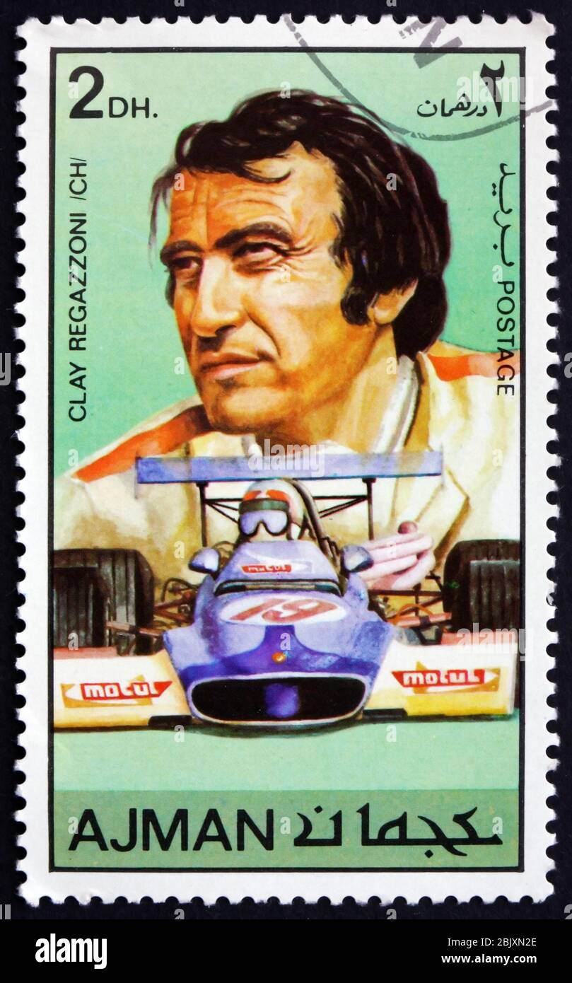 AJMAN - CIRCA 1971: a stamp printed in Ajman shows Gian-Claudio Giuseppe Clay Regazzoni, Swiss Racing Car Driver, circa 1971 Stock Photo