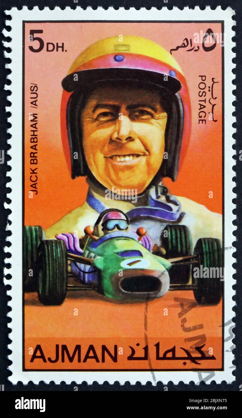 AJMAN - CIRCA 1971: a stamp printed in Ajman shows Sir Jack Brabham, Australian Racing Car Driver, circa 1971 Stock Photo