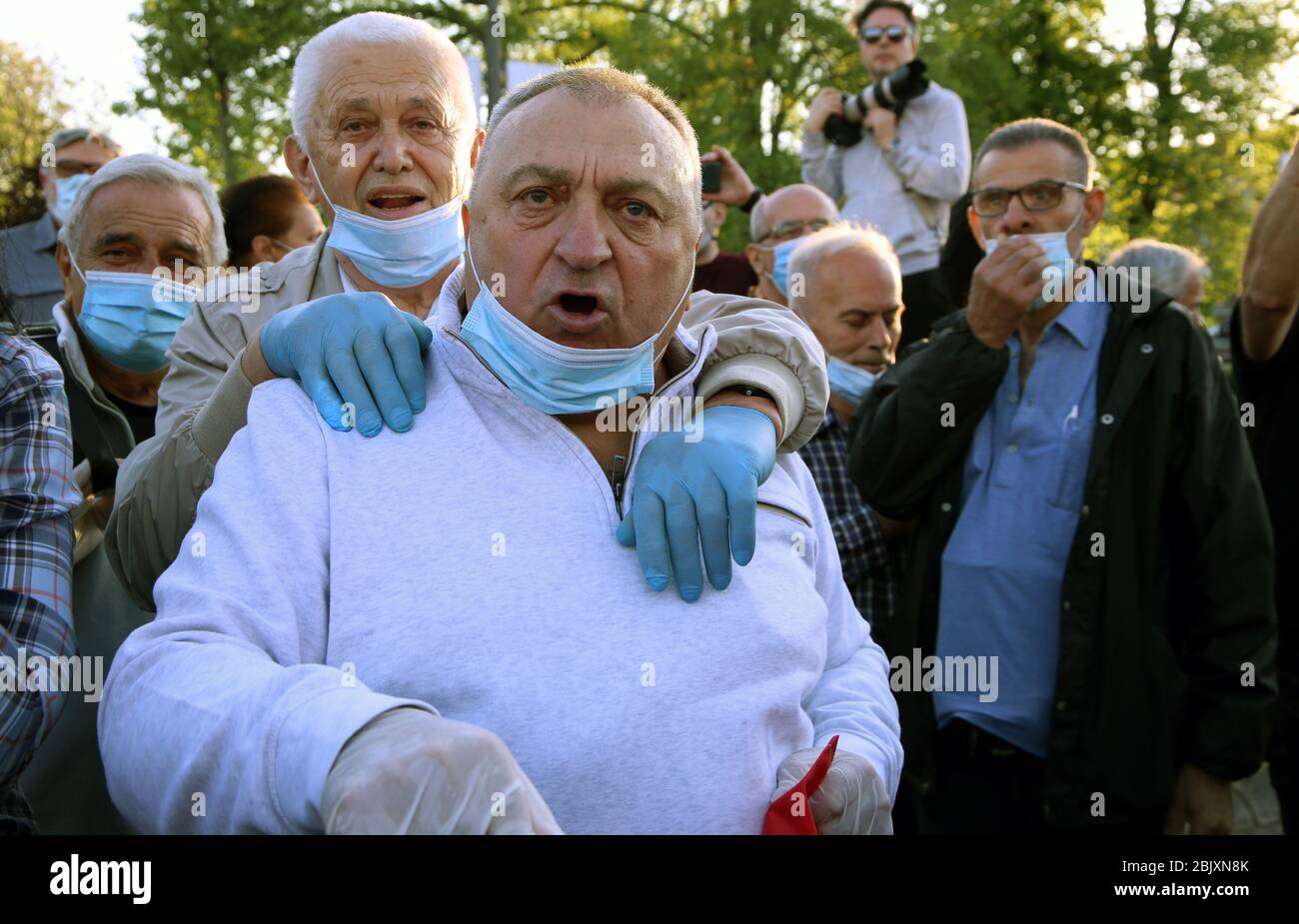 Belgrade, Serbia. 30th Apr 2020. Serbian opposition members wearing protective face masks attend the protest in front of the House of Parliament, amid the ongoing coronavirus COVID-19 pandemic. Serbian opposition and members of Alliance for Serbia protested in front of the parliament building against government policies to stem the spread of the pandemic COVID-19 disease caused by the SARS-CoV-2 coronavirus. Credit: Koca Sulejmanovic/Alamy Live News Stock Photo
