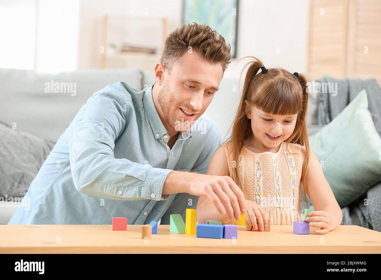 Portrait of happy father and his little daughter playing at home Stock ...