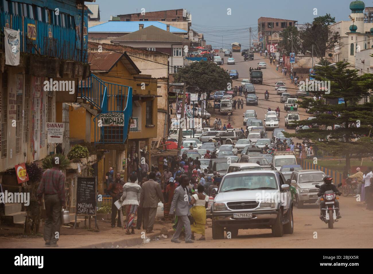 Bukavu, Democratic Republic of the Congo : Traffic on dusty central street of the city. Cars and motorbikes Stock Photo