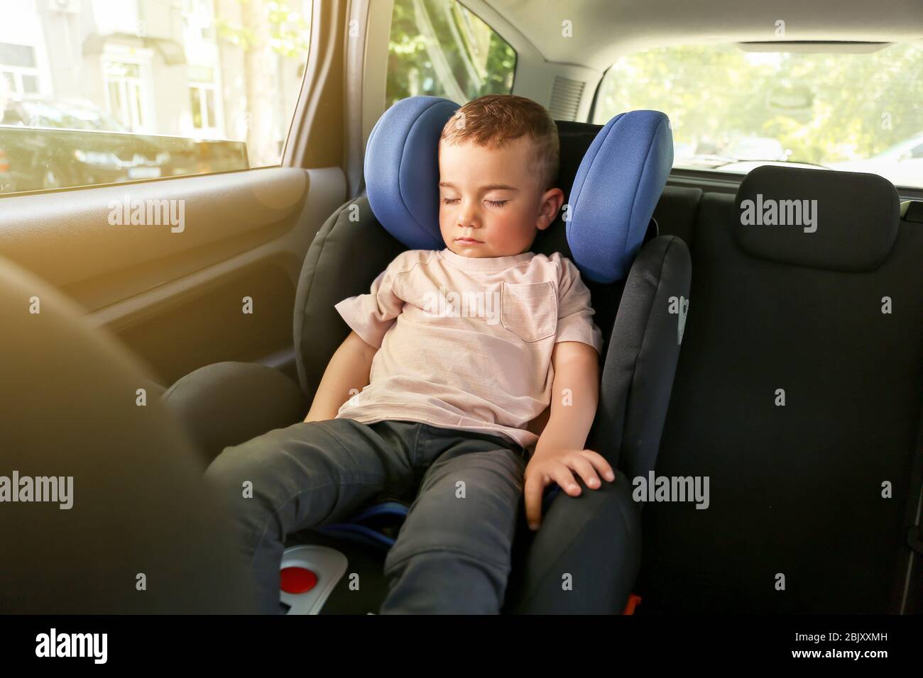 Baby boy sleeping on car safety seat Stock Photo Alamy