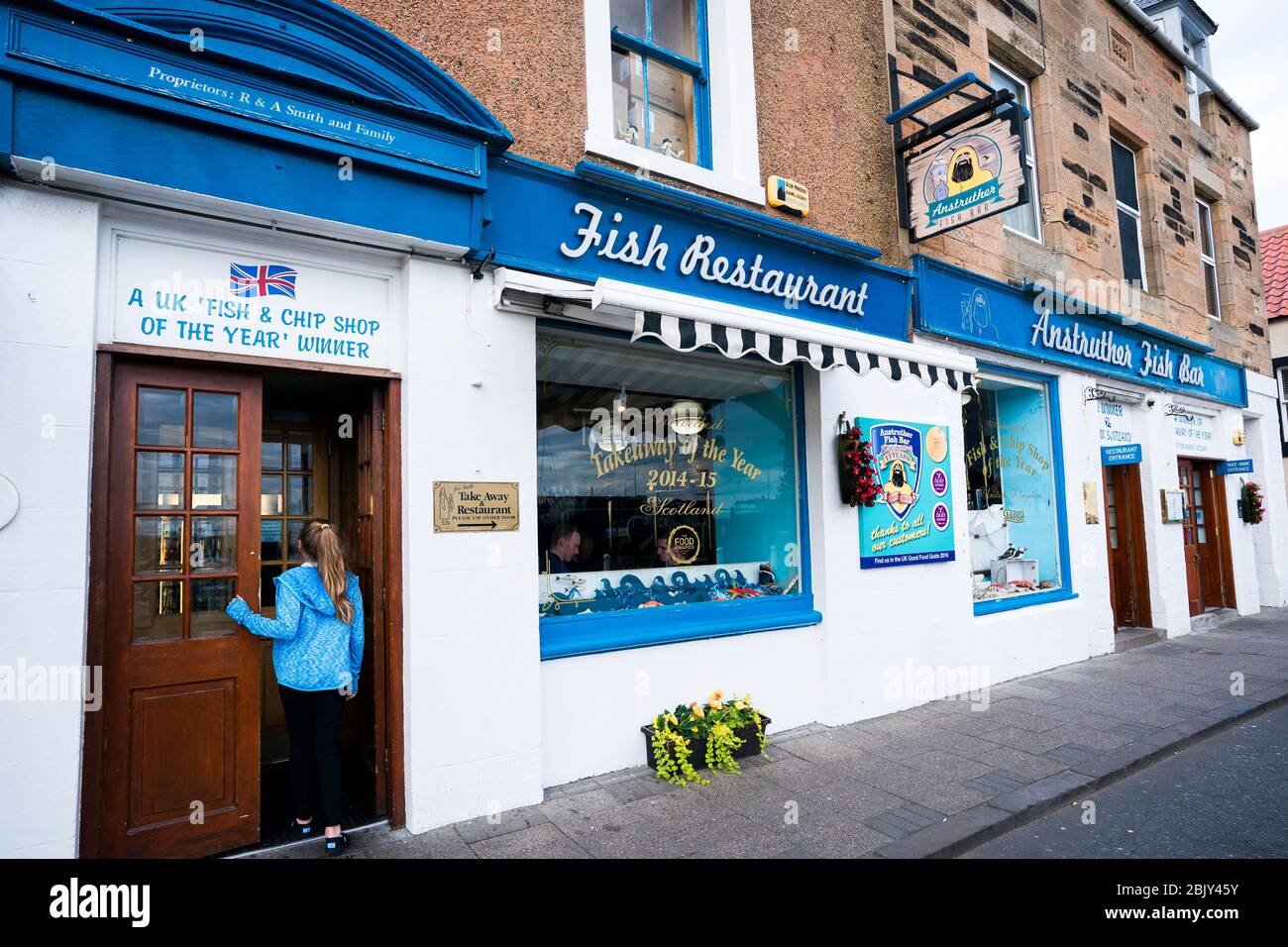Female tourist enters the famous Anstruther Fish Restaurant, Fishing village, Anstruther, Kingdom of Fife, Scotland, Europe Stock Photo