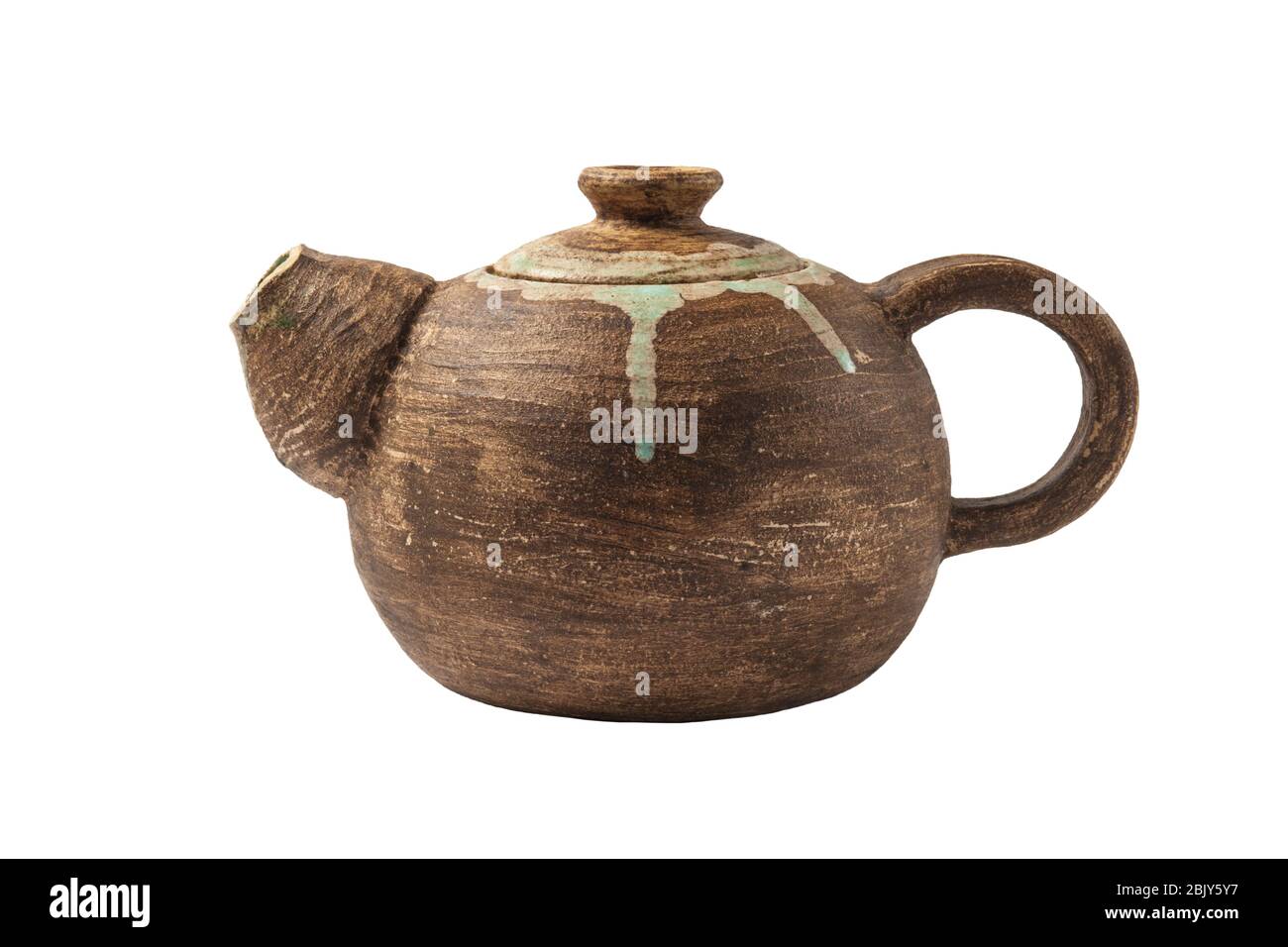 Handmade clay teapot Isolated on a white background. Antique pottery. Close-up. Stock Photo