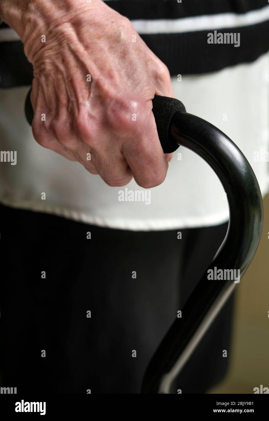 Close up of hand of senior woman holding cane Stock Photo