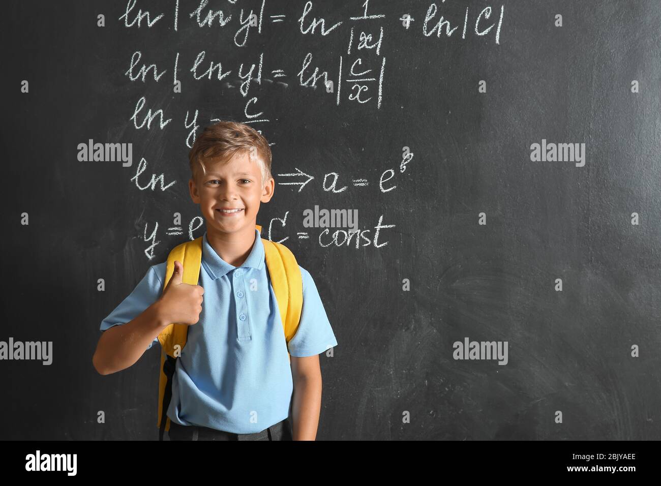 Little schoolboy showing thumb-up near blackboard Stock Photo - Alamy