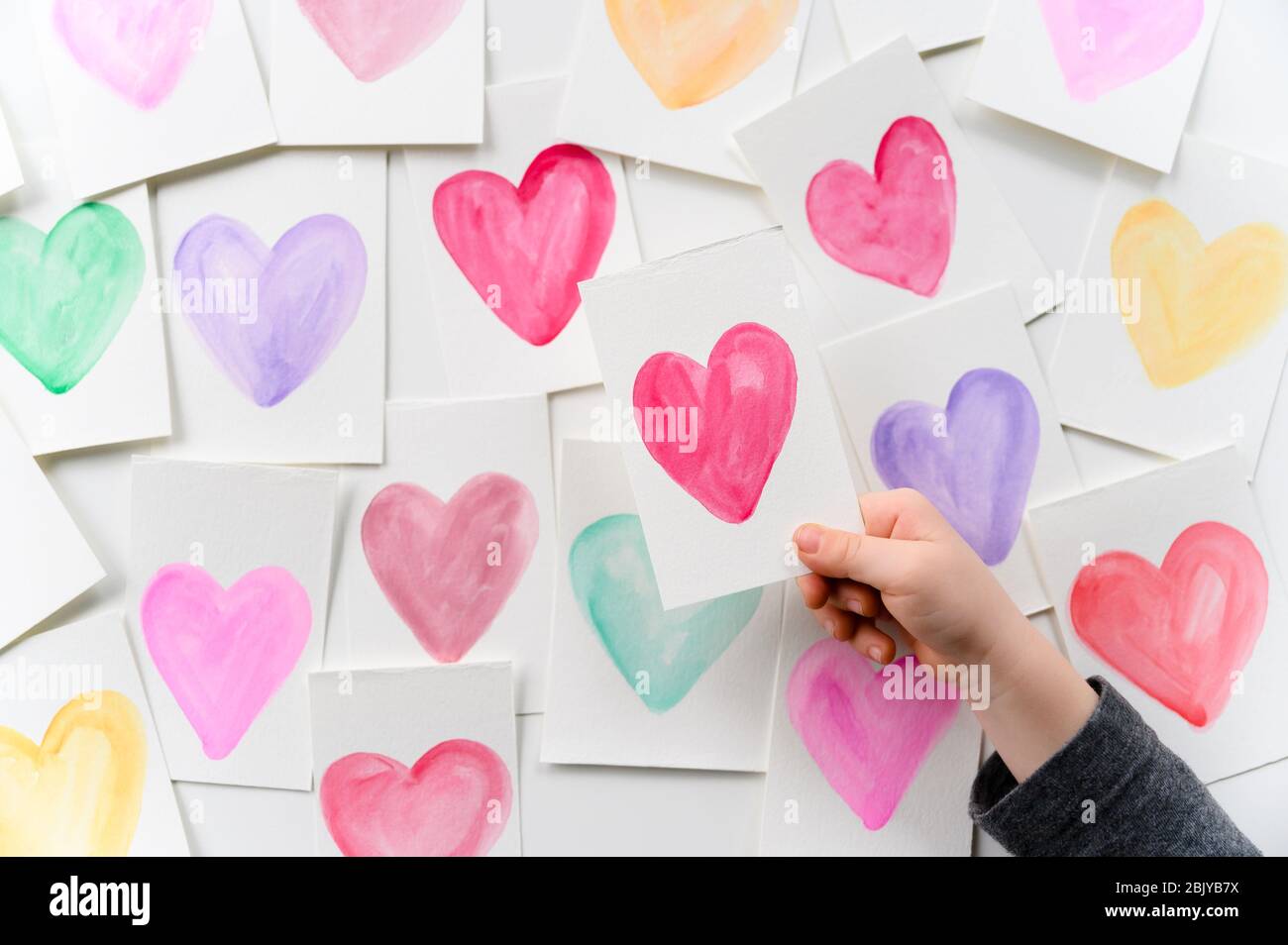 Child holding homemade Valentine card Stock Photo