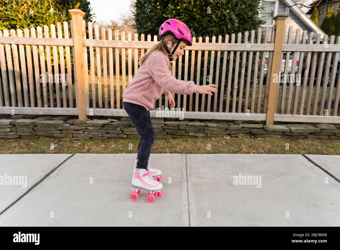 Girl learning how to rollerskate Stock Photo