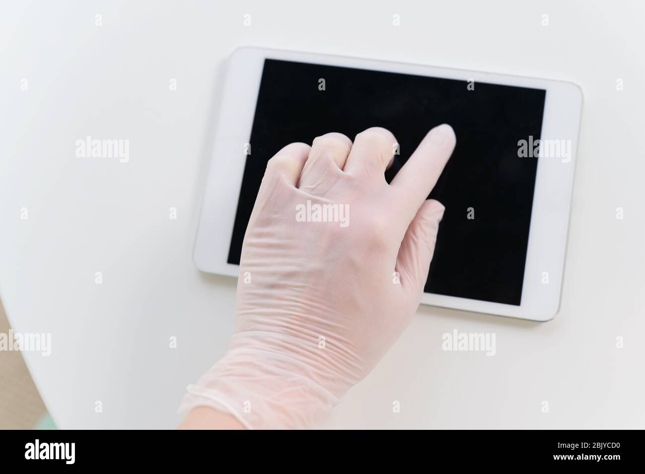 Hand in protective glove using tablet Stock Photo
