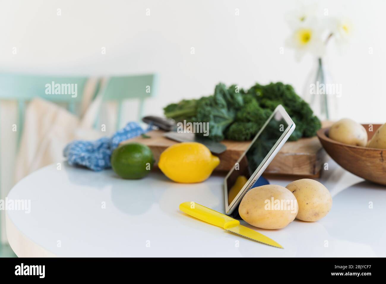 Tablet and vegetables on table Stock Photo