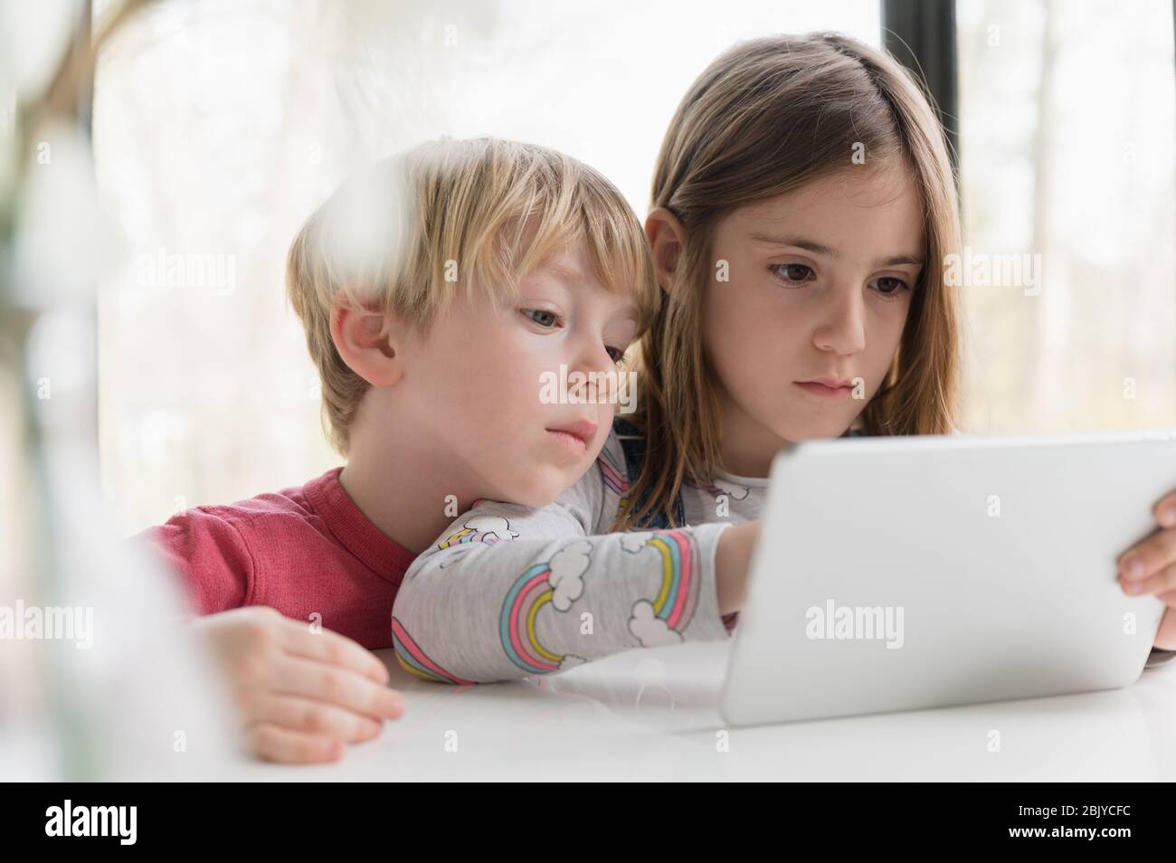 Children looking at tablet together Stock Photo