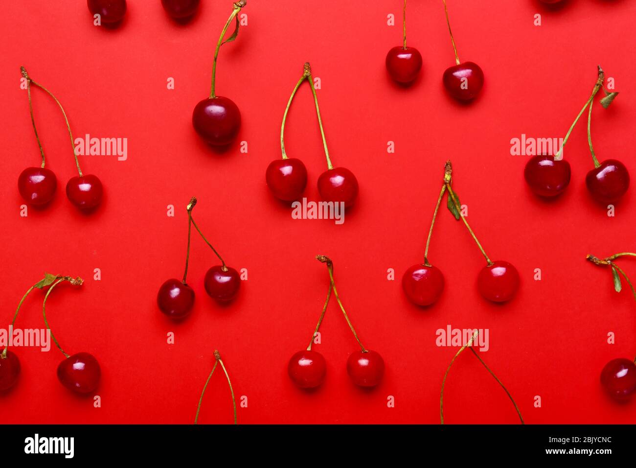 Many ripe sweet cherry on color background Stock Photo - Alamy