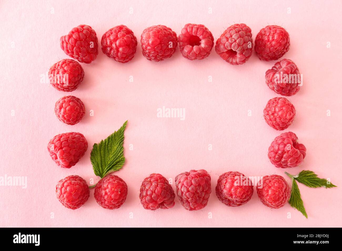 Frame made of sweet ripe raspberry on color background Stock Photo - Alamy