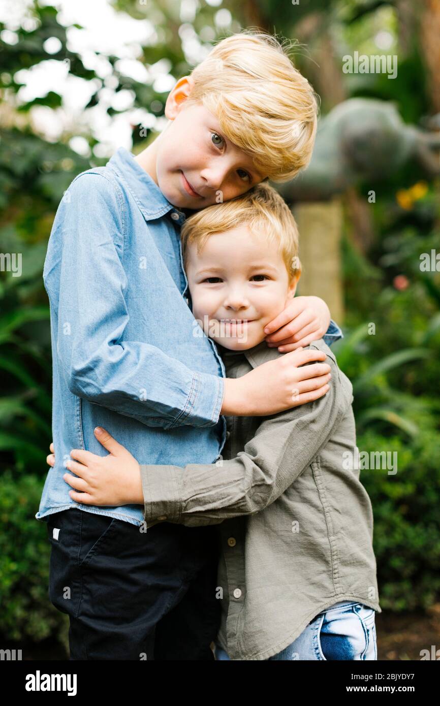 Portrait of brothers (4-5, 6-7) hugging Stock Photo