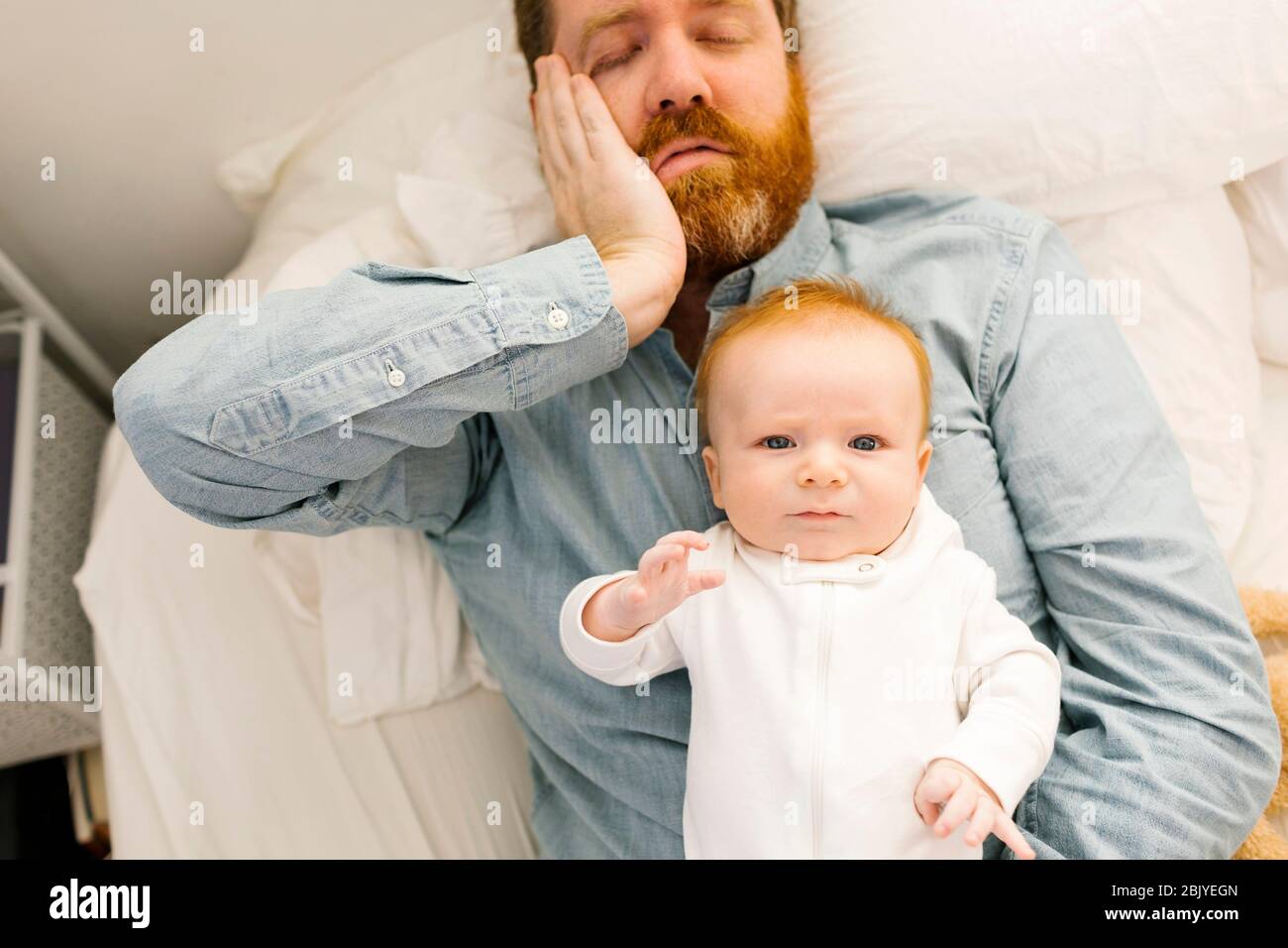 Father lying on bed with baby boy (2-3 months Stock Photo - Alamy