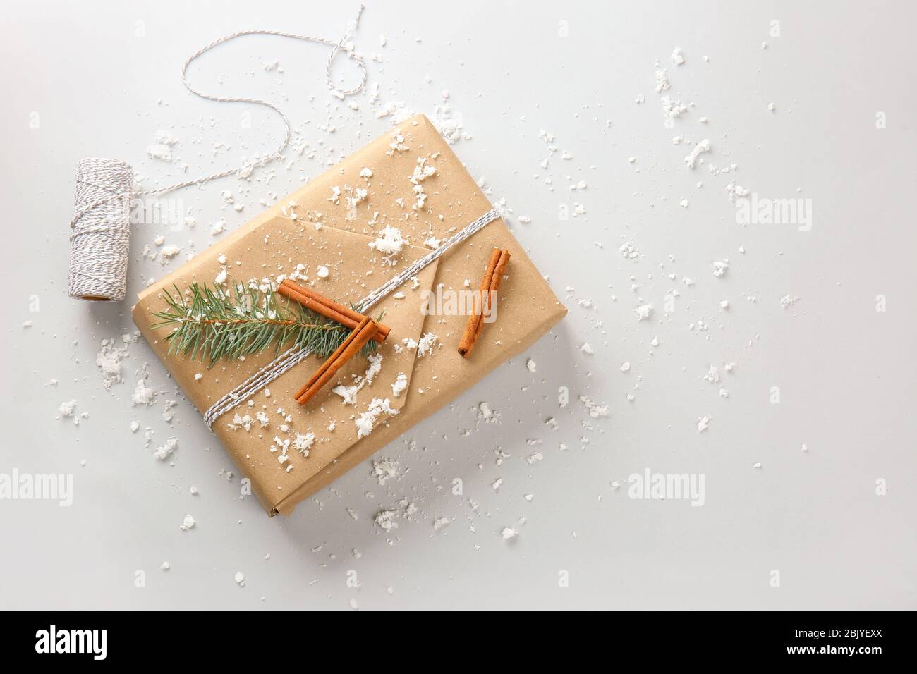 Beautiful Christmas gift box with threads on white background Stock Photo