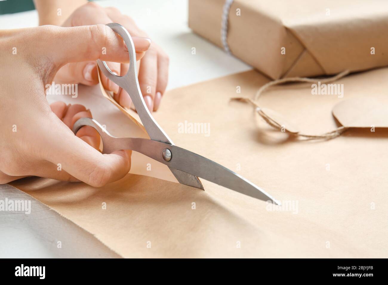 Premium Photo  Closeup image of girl cutting red wrapping paper for  christmas presents