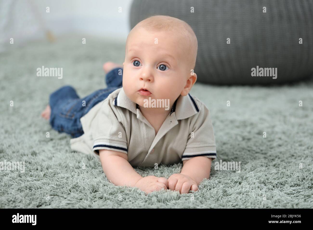 Adorable little baby crawling on soft carpet Stock Photo Alamy