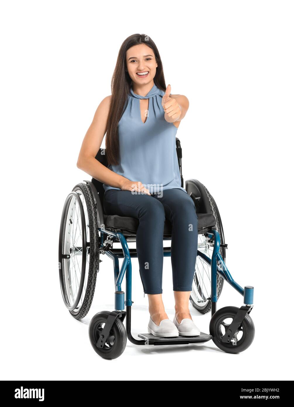 Happy businesswoman in wheelchair showing thumb-up gesture on white ...