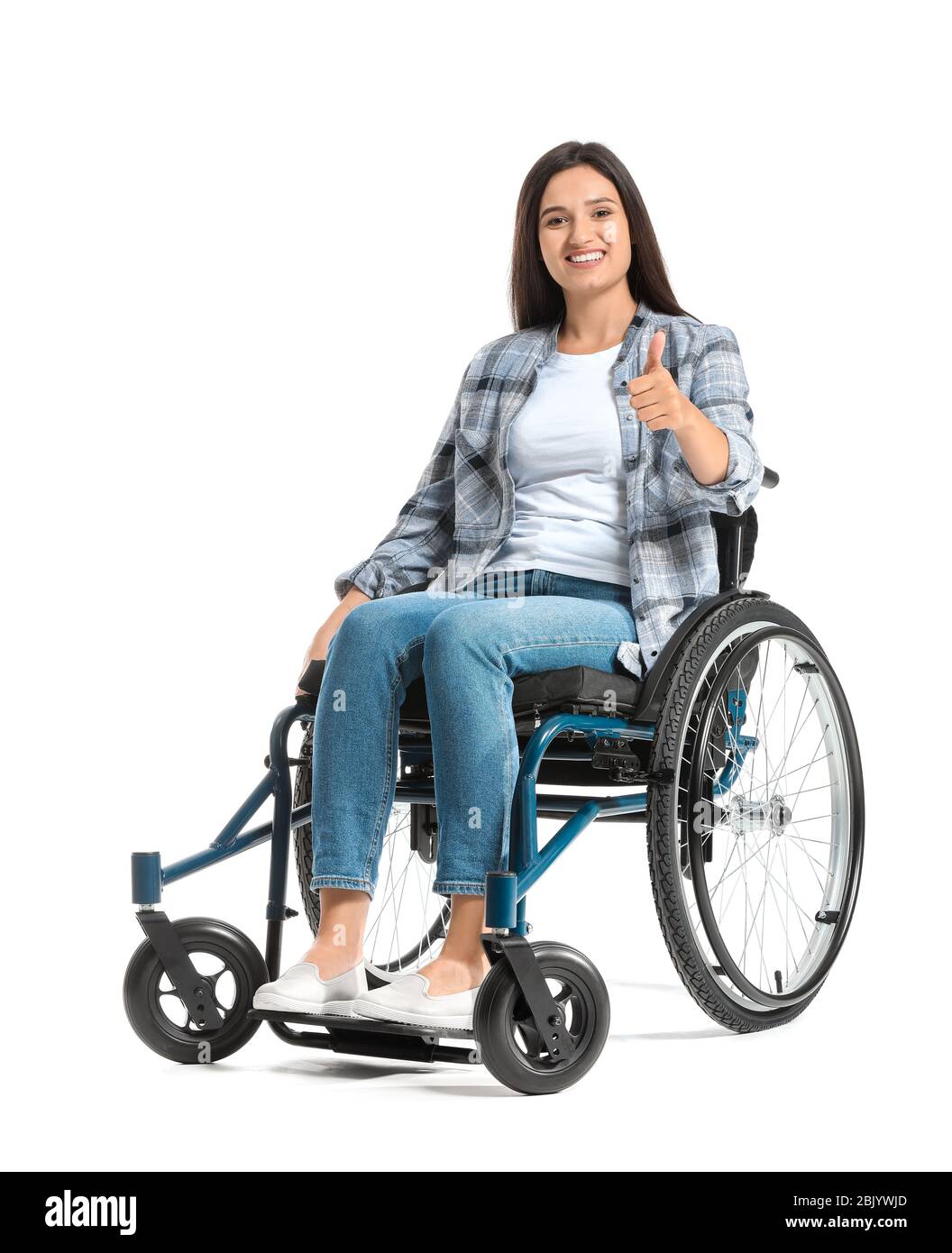 Happy woman in wheelchair showing thumb-up gesture on white background ...