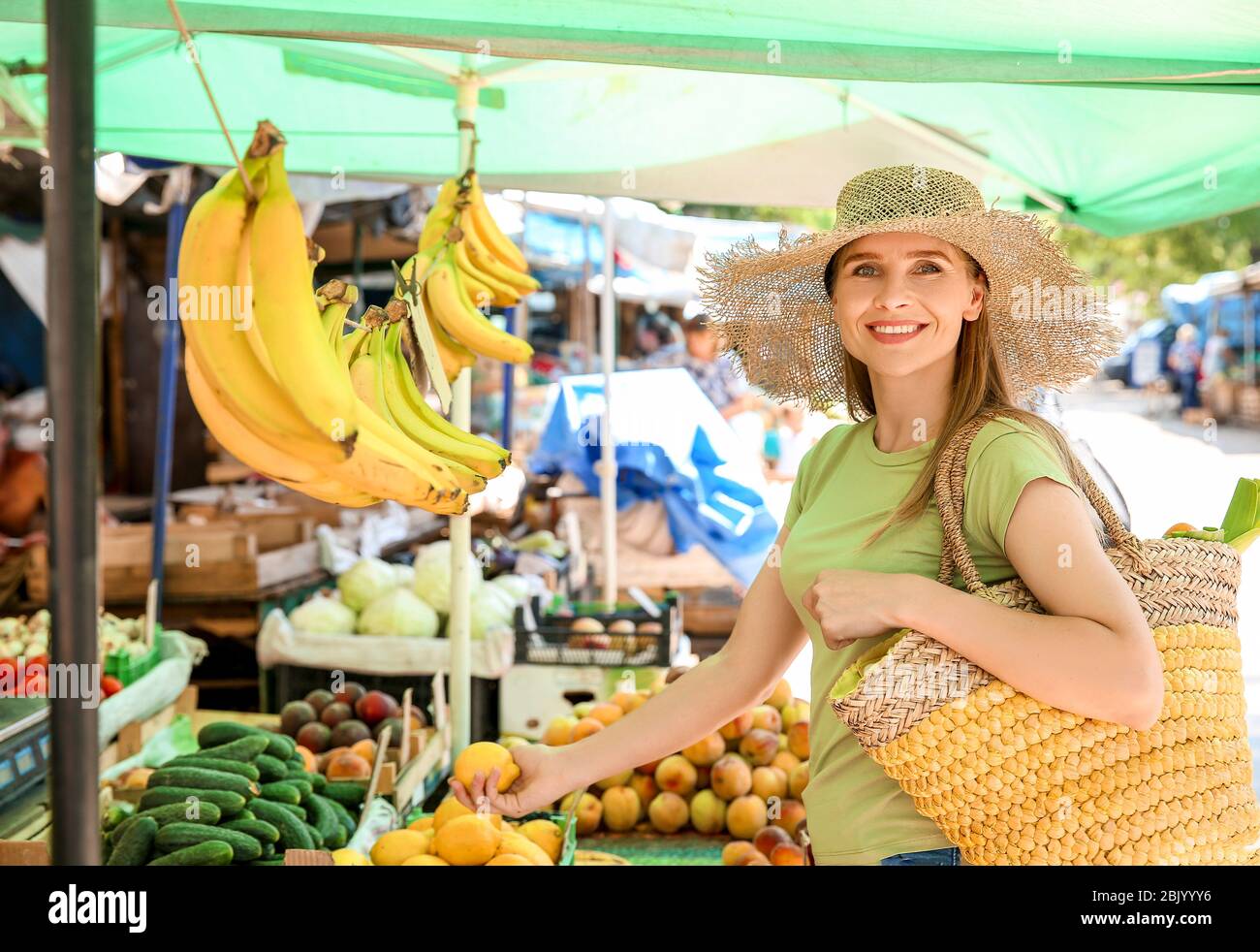 Woman choosing fruits at market Stock Photo - Alamy